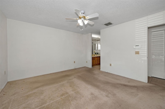 2446 Bentley Dr, Palm Harbor, FL 34684 - unfurnished room with light carpet, a textured ceiling, ceiling fan, and visible vents