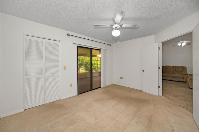 2446 Bentley Dr, Palm Harbor, FL 34684 - unfurnished bedroom featuring access to exterior, carpet floors, and a textured ceiling