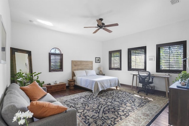 bedroom with wood-type flooring, visible vents, and ceiling fan