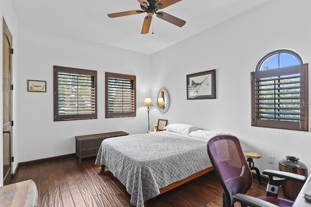 bedroom with a ceiling fan, hardwood / wood-style flooring, and baseboards