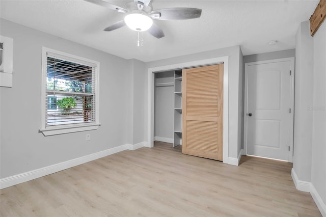 7 Georgia Ave, Crystal Beach, FL 34681 - unfurnished bedroom with baseboards, light wood finished floors, ceiling fan, a closet, and a textured ceiling