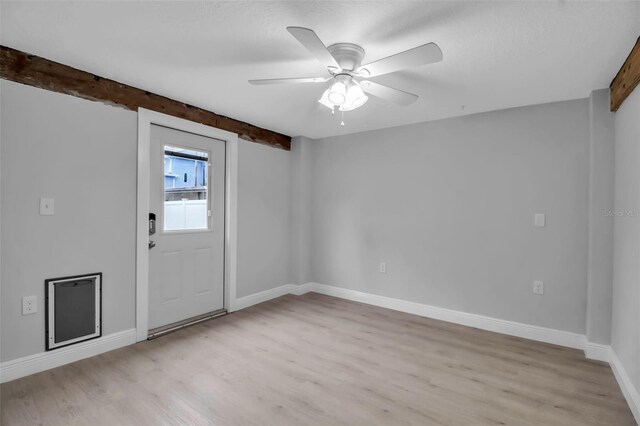 7 Georgia Ave, Crystal Beach, FL 34681 - interior space with light wood finished floors, beam ceiling, baseboards, and a ceiling fan
