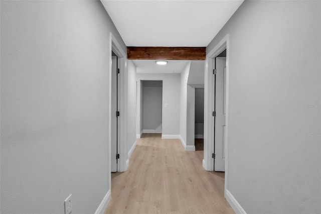 7 Georgia Ave, Crystal Beach, FL 34681 - corridor with baseboards, beam ceiling, and light wood finished floors