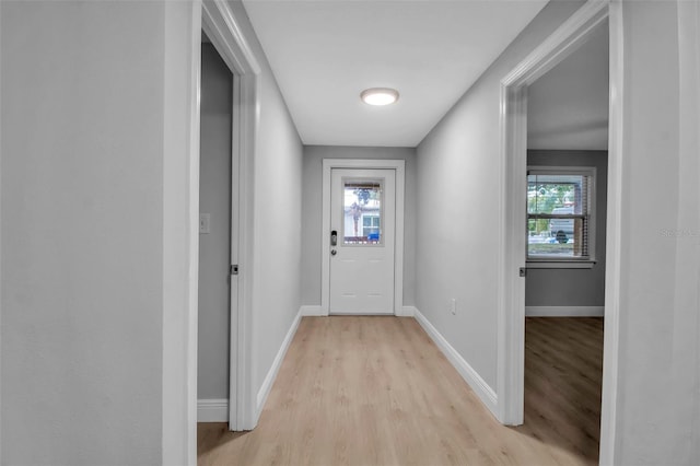 7 Georgia Ave, Crystal Beach, FL 34681 - doorway to outside with light wood-style flooring and baseboards