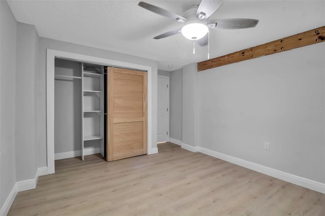 7 Georgia Ave, Crystal Beach, FL 34681 - unfurnished bedroom featuring a closet, baseboards, and light wood-style floors