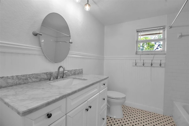7 Georgia Ave, Crystal Beach, FL 34681 - bathroom with wainscoting, toilet, vanity, and bathing tub / shower combination