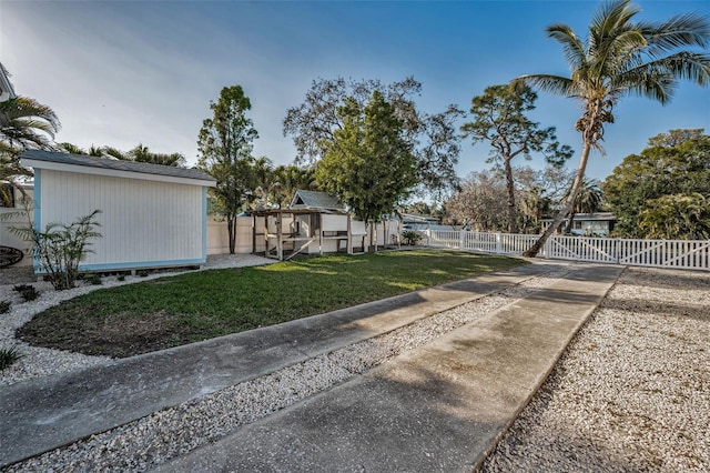 7 Georgia Ave, Crystal Beach, FL 34681 - view of yard with an outbuilding and fence