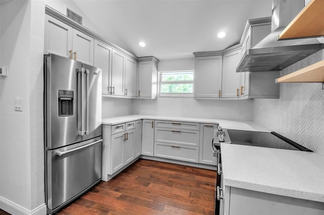 7 Georgia Ave, Crystal Beach, FL 34681 - kitchen featuring dark wood-type flooring, gray cabinets, appliances with stainless steel finishes, wall chimney exhaust hood, and decorative backsplash