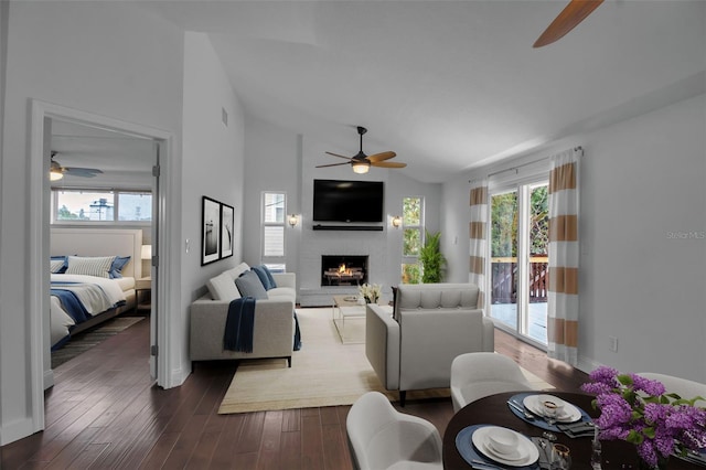 7 Georgia Ave, Crystal Beach, FL 34681 - living area featuring baseboards, vaulted ceiling, a fireplace, a ceiling fan, and dark wood-style flooring