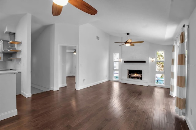 7 Georgia Ave, Crystal Beach, FL 34681 - unfurnished living room with baseboards, ceiling fan, lofted ceiling, a fireplace, and dark wood-style flooring