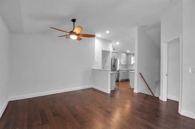 7 Georgia Ave, Crystal Beach, FL 34681 - unfurnished living room with baseboards, dark wood-type flooring, a ceiling fan, and vaulted ceiling