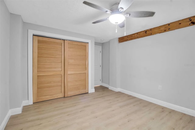 7 Georgia Ave, Crystal Beach, FL 34681 - unfurnished bedroom featuring a closet, baseboards, and wood finished floors