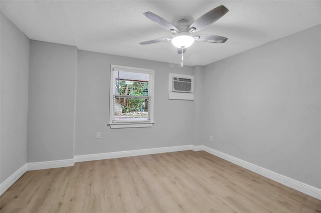 7 Georgia Ave, Crystal Beach, FL 34681 - empty room with ceiling fan, light wood-style floors, baseboards, and a wall mounted AC