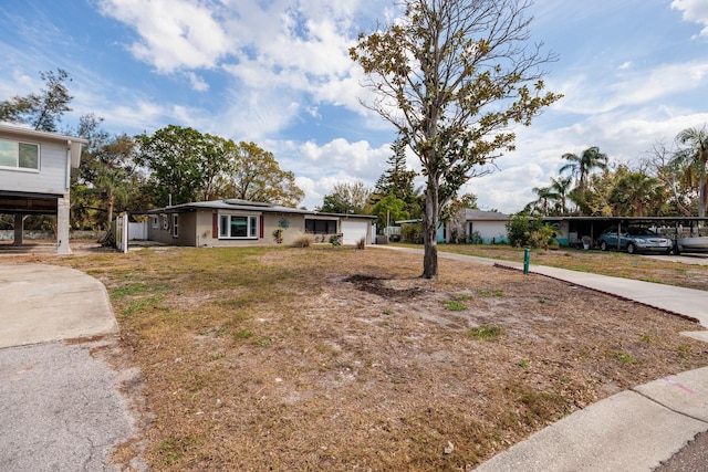 single story home featuring a front yard and roof mounted solar panels