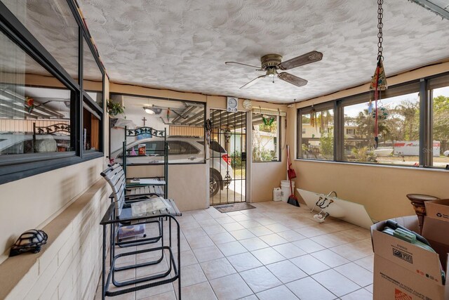 sunroom / solarium featuring ceiling fan