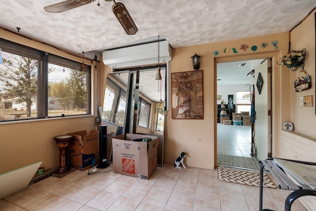 interior space with ceiling fan