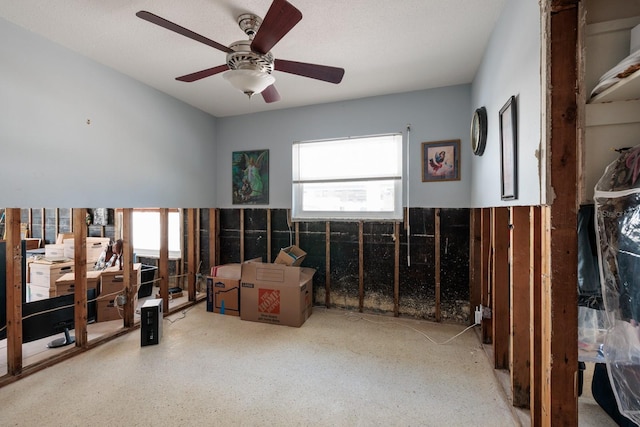 misc room featuring wainscoting and ceiling fan