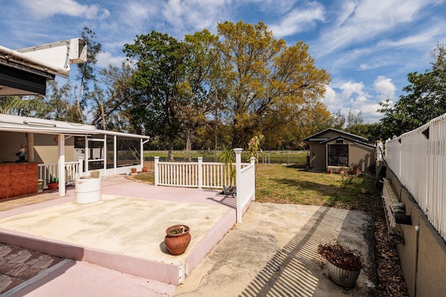 view of patio with a sunroom, a fenced backyard, and an outbuilding