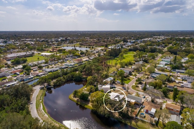 birds eye view of property with a water view and a residential view