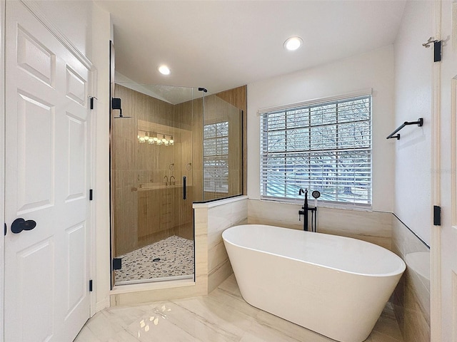 full bathroom with a freestanding tub, recessed lighting, marble finish floor, and a stall shower