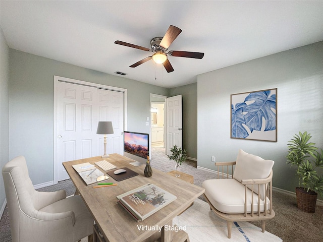 office area featuring carpet floors, baseboards, visible vents, and a ceiling fan