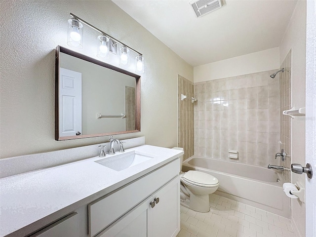 bathroom with visible vents, toilet,  shower combination, tile patterned flooring, and vanity