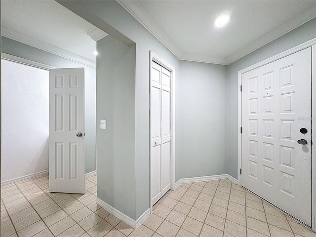 foyer with ornamental molding, baseboards, and light tile patterned floors