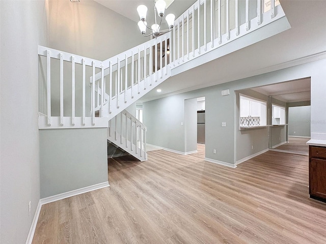 interior space featuring stairs, baseboards, and wood finished floors