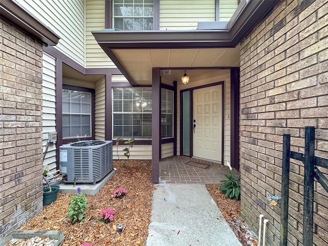 entrance to property with central AC and brick siding