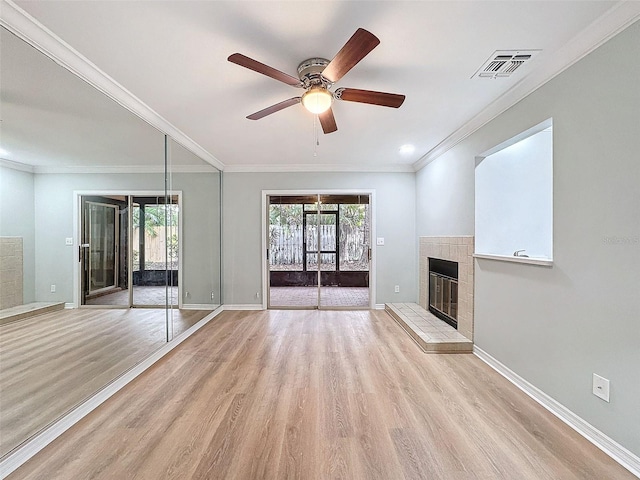 unfurnished living room featuring a fireplace, visible vents, light wood-style floors, a ceiling fan, and baseboards