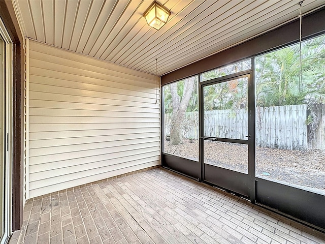 unfurnished sunroom with wood ceiling