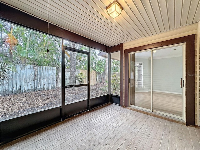 unfurnished sunroom with wooden ceiling