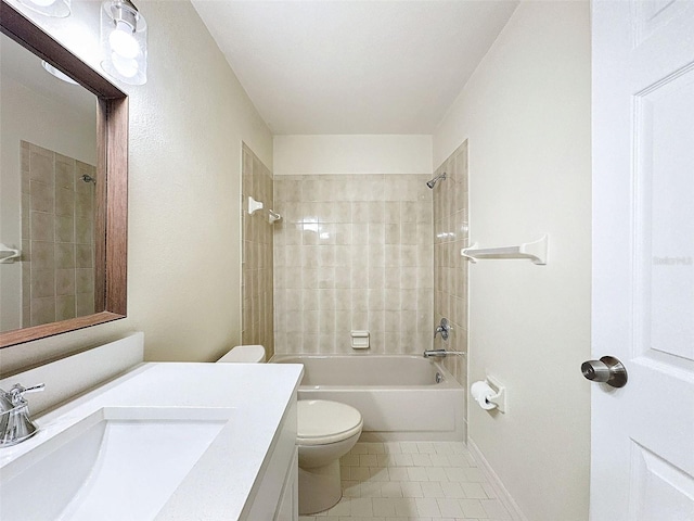 bathroom with shower / bath combination, toilet, vanity, baseboards, and tile patterned floors