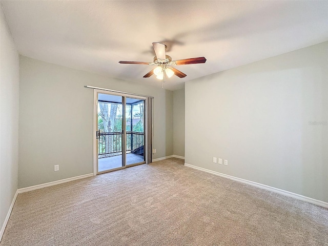 unfurnished room featuring carpet, baseboards, and a ceiling fan