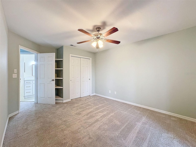 unfurnished bedroom featuring a closet, carpet flooring, visible vents, and baseboards