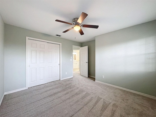 unfurnished bedroom featuring a closet, carpet flooring, visible vents, and baseboards