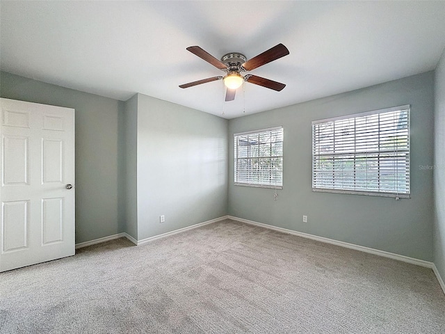 unfurnished room featuring ceiling fan, carpet flooring, and baseboards