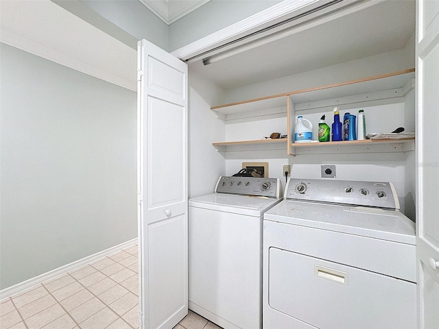 laundry area featuring laundry area, light tile patterned floors, baseboards, and separate washer and dryer