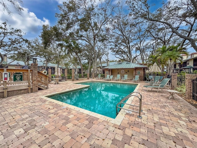 pool featuring a patio and fence