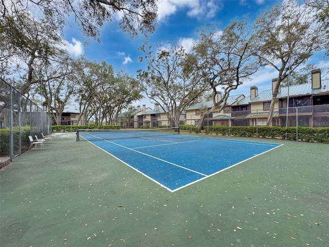 view of sport court featuring a residential view and fence