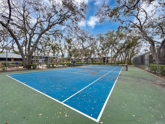 view of sport court featuring fence and a residential view