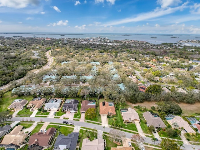 drone / aerial view featuring a residential view and a water view