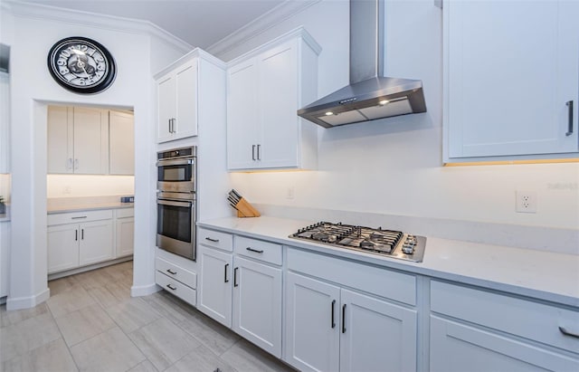 kitchen with crown molding, stainless steel appliances, light countertops, white cabinets, and exhaust hood