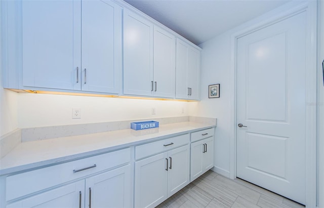 kitchen with white cabinetry and light countertops