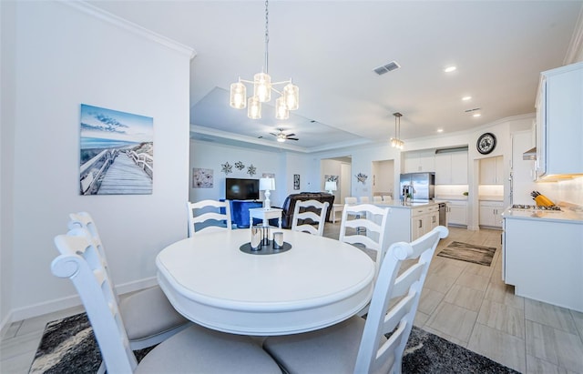 dining space featuring recessed lighting, ceiling fan with notable chandelier, visible vents, and ornamental molding