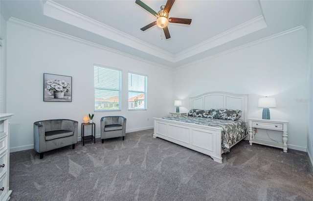 carpeted bedroom featuring ornamental molding, a raised ceiling, a ceiling fan, and baseboards