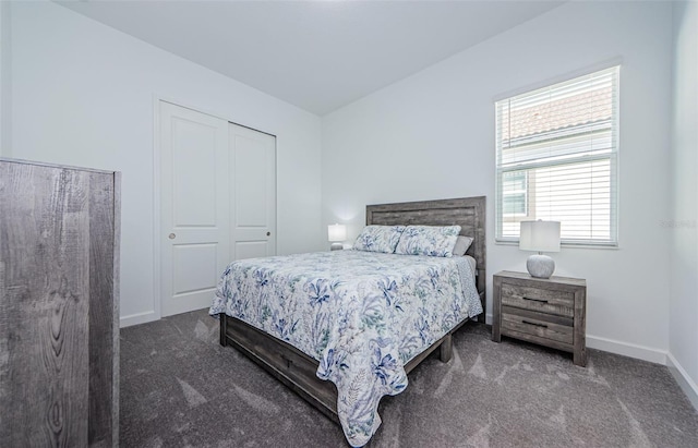 carpeted bedroom with baseboards and a closet