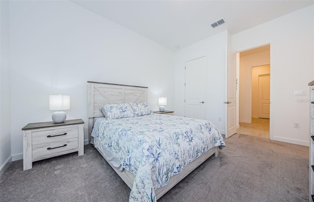 carpeted bedroom with vaulted ceiling, visible vents, and baseboards