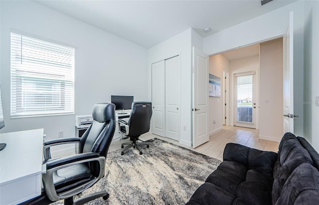 office space with baseboards and wood finished floors