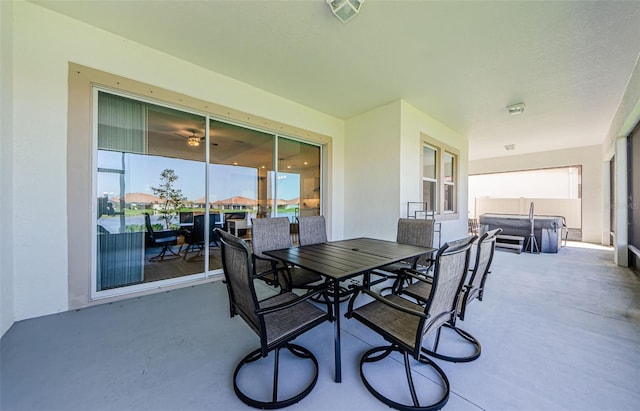 view of patio / terrace with outdoor dining area, visible vents, and a hot tub